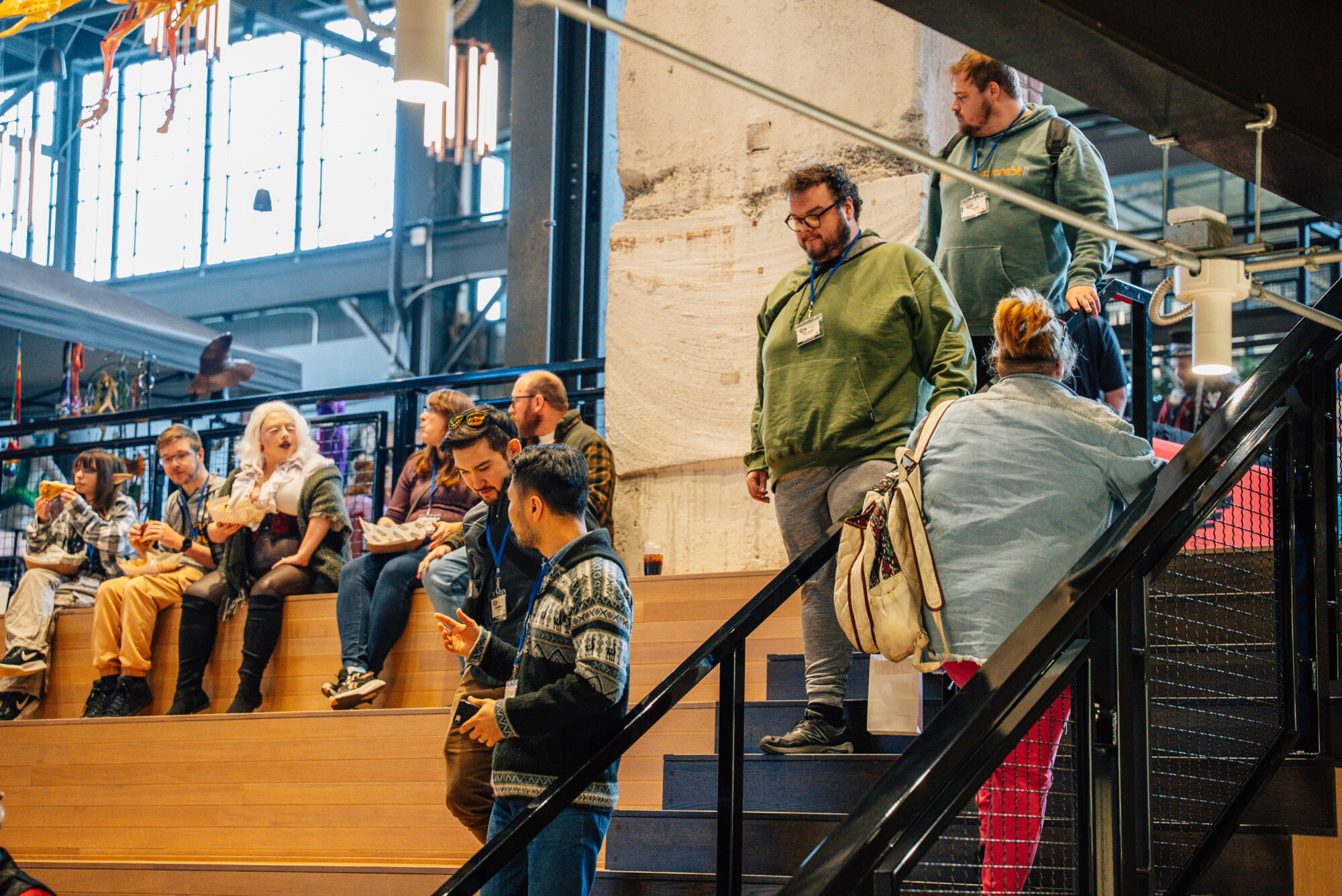 People gathering at a stadium seated area at the Fort Wayne Electric Works - The Forum space.